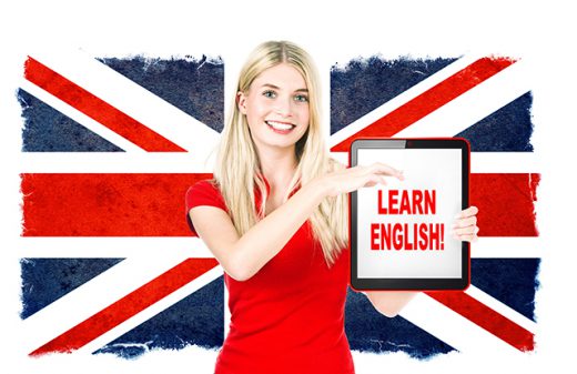 young woman holding tablet pc on the background with british national flag. english learning concept